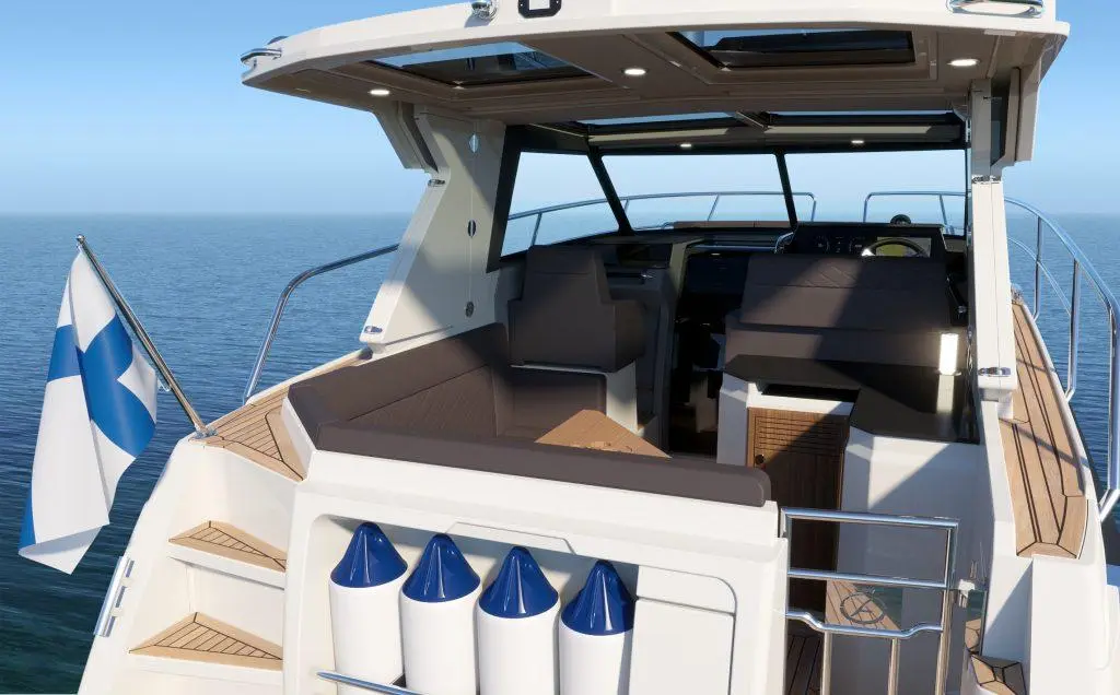 A modern boat interior with a Finnish flag, seating area, helm, and light wood finishes against a serene sea backdrop.